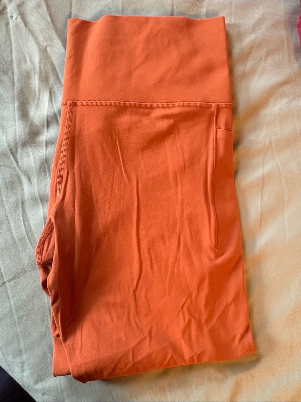 Athleta Burnt Orange Salutation Stash Pocket Tight